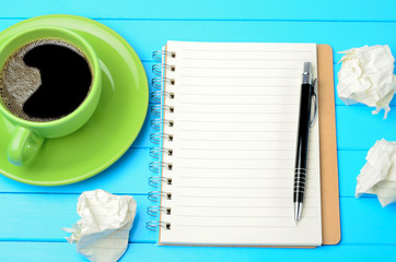 Notepad with crumpled paper and coffee
