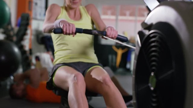  Woman working out on rowing machine at the gym