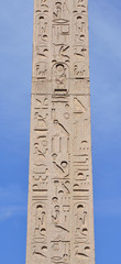 Hieroglyph script on ancient egyptian obelisk in the center of Piazza del Popolo square, Rome