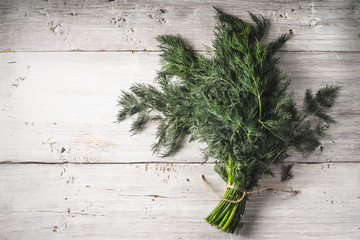 Bunch of dill on the white wooden table horizontal