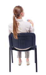back view of young beautiful  woman sitting on chair.  girl  watching. Rear view people collection.  backside view of person.  Isolated over white background. Skinny girl sitting on an office chair in