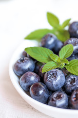 Blueberries in white plate with mint