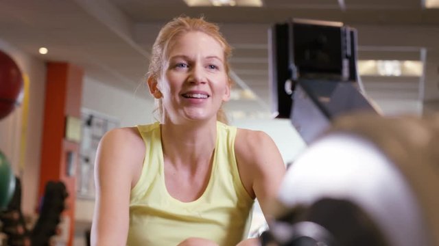  Woman working out on rowing machine at the gym