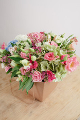 hydrangea rich bouquet. Vintage floristic background, colorful roses, in crafting the package on the wooden table