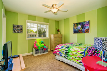 Adorable kids room in green color with bright colorful bedding