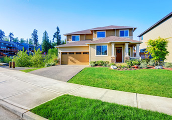 Beautiful curb appeal of luxury beige house.