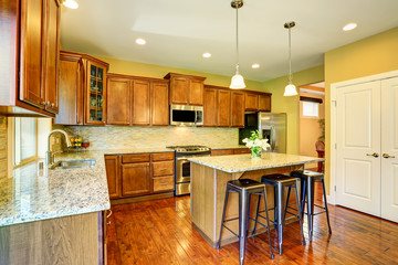 Wooden kitchen interior with kitchen island and cabinets.