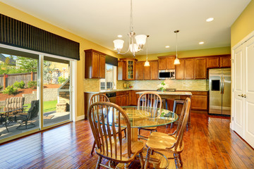 Wooden kitchen and dining room interior.
