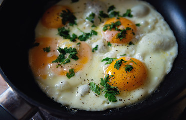 Classically fried eggs on a pan seasoned with parsley. Delicious fresh breakfast idea. - 118456909