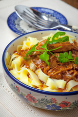 Tagliatelle with dark sauce.