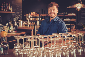 Handsome barman having fun at bar counter in bakery.