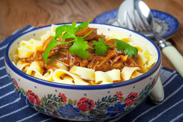 Tagliatelle with dark sauce.