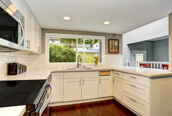 White kitchen room interior With hardwood floor.