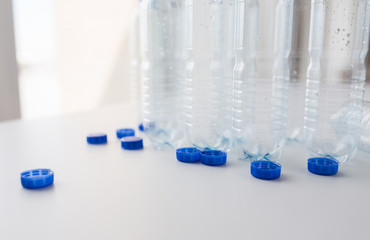 close up of empty water bottles and caps on table