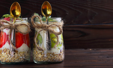 Two jar with hommemade oat flakes with fresh yogurt with kiwi an