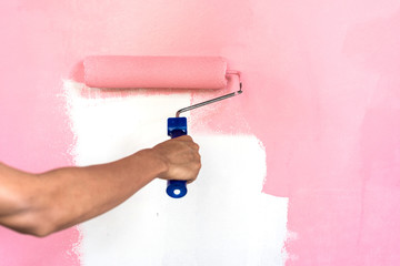 hand painting wall with paint roller