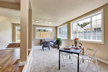 Hallway interior in beige walls. Living room connected to dining area.