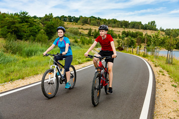 Teenage girl and boy cycling 