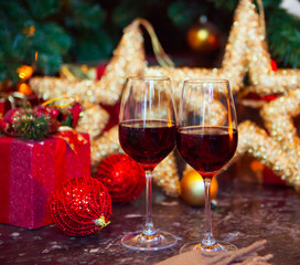 Two glasses of red wine on a Christmas tree background
