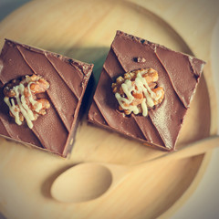 Chocolate Almond Brownies on wooden plate and spoon with vintage