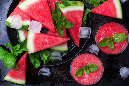 Watermelon slices and drink on a grunge table