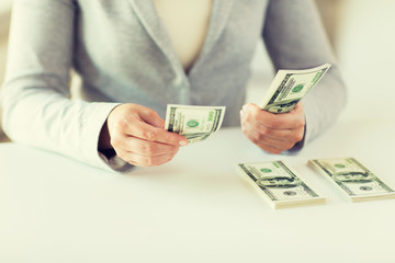 close up of woman hands counting us dollar money