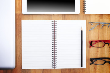 Businessman write a short note on opened notebook with pen and glasses. Flat layout and copy space.