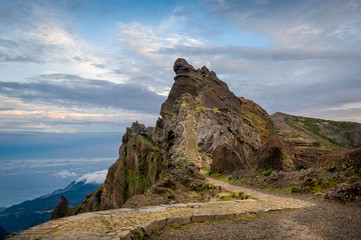 Sunset view of rocky mountain peak on the hiking path Pico Arieiro.