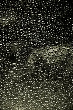 black and white closeup drops water on glass background