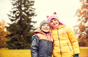 happy little girl and boy in autumn park