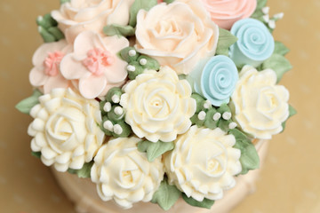 Wedding or birthday cake decorated with flowers made from cream,