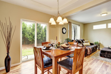 Dining area with wooden table set connected to living room.
