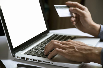 man's hands holding credit card and using laptop. Online shopping