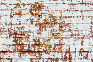 Scratched up white painted brick wall