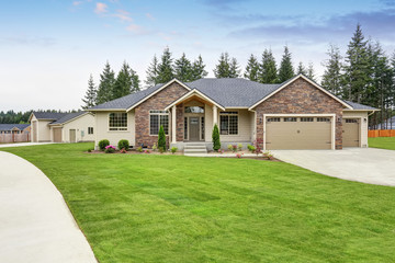 Luxury one level house exterior with brick trim and garage