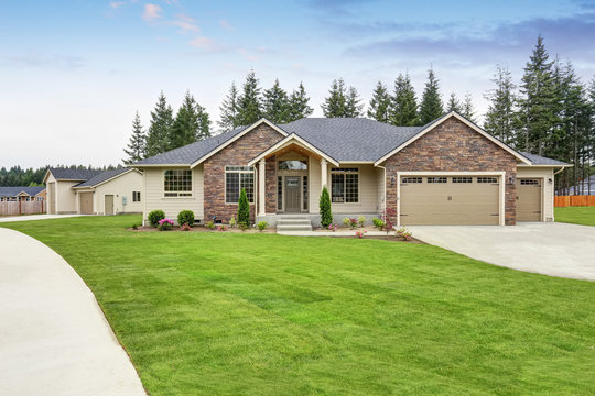 Luxury One Level House Exterior With Brick Trim And Garage