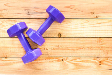 top view fo fitness dumbbell on wooden floor