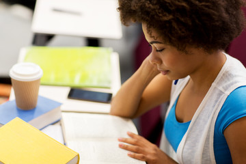 student girl with books and coffee on lecture