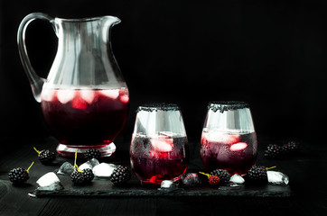 Blackberry drink in glasses with black sugar rim for fall and halloween parties