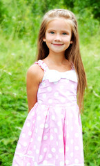 Fototapeta na wymiar Portrait of adorable smiling little girl in summer day