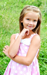 Portrait of adorable smiling little girl in summer day