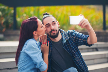 Young Couple Taking Selfie at Park