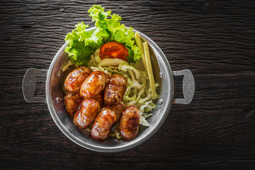 Grill sausages with metal plate on the table