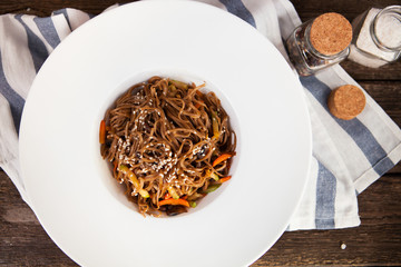 Tasty Soba noodles with vegetables in sweet and sour sauce on ol
