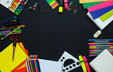 School supplies on blackboard background ready for your design