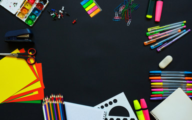 School supplies on blackboard background ready for your design