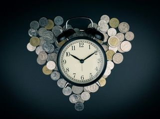 saving time, Alarm clock with coins isolated on black background. with vintage filter