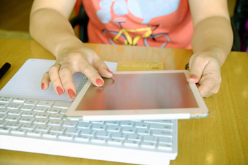 Woman's hands holding credit card and using laptop. Online shopping