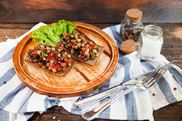 Italian tomato bruschetta with chopped vegetables, herbs and oil