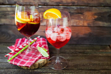 Sangria  and ingredients in glasses  on a rustic wood